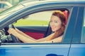 Happy beautiful young woman driving her new blue car Royalty Free Stock Photo