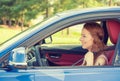 Happy beautiful young woman driving her new blue car Royalty Free Stock Photo