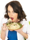 Happy Beautiful Young Woman Eating a Plate of Spaghetti Carbonara Pasta Royalty Free Stock Photo