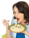 Happy Beautiful Young Woman Eating a Plate of Spaghetti Carbonara Pasta Royalty Free Stock Photo