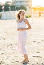 Happy beautiful young woman enjoying sun and wind at the sand beach Royalty Free Stock Photo