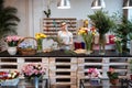 Happy beautiful young woman florist standing in flower shop Royalty Free Stock Photo