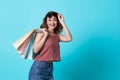 Happy beautiful young woman hand holding shopping bag  over blue background Royalty Free Stock Photo