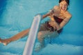 Happy Beautiful young woman having fun and smiling in pool, relaxing and enjoying summer holiday. Brunette girl on vacation in Royalty Free Stock Photo