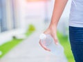Happy beautiful young woman holding drinking water bottle in her hand. Royalty Free Stock Photo