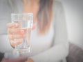 Happy beautiful young woman holding drinking water glass in her hand. Royalty Free Stock Photo