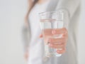 Happy beautiful young woman holding drinking water glass in her hand. Royalty Free Stock Photo