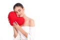 Beautiful young woman holding red cushion heart shape smiling isolated in white background with copyspace.love romance and Royalty Free Stock Photo
