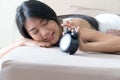 Young woman look alarmclock lying on a bed at home Royalty Free Stock Photo