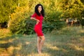 Happy beautiful young woman in red dress relax in summer park. Freedom concept Royalty Free Stock Photo