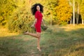 Happy beautiful young woman in red dress relax in summer park. Freedom concept Royalty Free Stock Photo