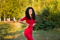 Happy beautiful young woman in red dress relax in summer park. Freedom concept Royalty Free Stock Photo