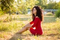 Happy beautiful young woman in red dress relax in summer park. Freedom concept Royalty Free Stock Photo