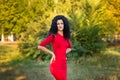 Happy beautiful young woman in red dress relax in summer park. Freedom concept Royalty Free Stock Photo