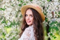 Happy beautiful young woman in spring blossom park Royalty Free Stock Photo