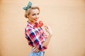 Happy beautiful young woman standing and eating sweet lollipop Royalty Free Stock Photo