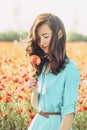 Happy woman with poppy flower in the field. Royalty Free Stock Photo