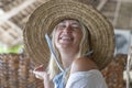 Happy beautiful young woman in a straw hat on a tropical beach, close up portrait Royalty Free Stock Photo