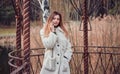 Happy beautiful young woman talking on mobile phone in the gazebo Royalty Free Stock Photo