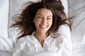 Happy beautiful young woman waking up in bed, top view Royalty Free Stock Photo