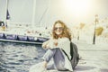 Happy beautiful young woman woman on sea and port background, tr Royalty Free Stock Photo