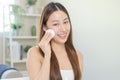 Happy beauty, beautiful asian young woman, girl smiling, looking in mirror, holding cotton pad, applying lotion by wipe on her Royalty Free Stock Photo