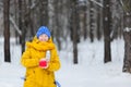 Happy beauty woman basking in the winter a hot drink. Royalty Free Stock Photo