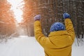 Happy beauty woman wins at sunset in the Park in winter.