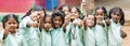 Happy best children friends girls classmates smiling showing thumb up gesture at the school. Multiethnic school kids enjoying