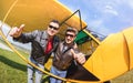 Happy best friends taking selfie at aeroclub with ultra light airplane