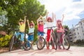 Happy bicycle riders standing in city park Royalty Free Stock Photo