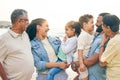 Happy, big family and beach vacation in nature bonding, laugh and relax outdoor together. Smile, love and children with Royalty Free Stock Photo