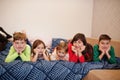 Happy big family is having fun together in bedroom. Large family morning concept. Mother with four kids wear pajamas in bed at Royalty Free Stock Photo