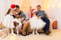 Happy big family portrait, celebrating new year or Christmas - parents and children in home interior decorated with holiday lights Royalty Free Stock Photo