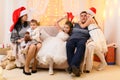 Happy big family portrait, celebrating new year or Christmas - parents and children in home interior decorated with holiday lights Royalty Free Stock Photo