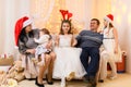 Happy big family portrait, celebrating new year or Christmas - parents and children in home interior decorated with holiday lights Royalty Free Stock Photo