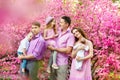 Happy big family of six are standing in spring park. Happy loving family concept. Happy family having fun on sakura garden Royalty Free Stock Photo