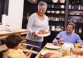 Happy, big family and turkey with child for thanksgiving dinner, meal or food at the table. Grandparents, little boy or Royalty Free Stock Photo