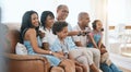 Happy, big family and watching tv on the sofa together, enjoying a film or comedy show at home. Smile, living room and Royalty Free Stock Photo