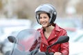 Happy biker on a motorbike looking at you