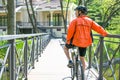 Happy biker ride on road in summer city park. Sport relax concept Royalty Free Stock Photo