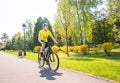 Happy biker ride on road in summer city park. Sport relax concept Royalty Free Stock Photo