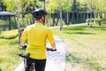 Happy biker ride on road in summer city park. Sport relax concept Royalty Free Stock Photo