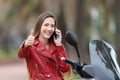 Happy biker with thumbs up on the phone