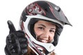 Happy biker woman with a motocross helmet and thumb up