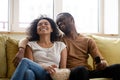 Happy biracial couple have fun watching TV together Royalty Free Stock Photo