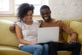 Happy biracial couple have fun watching video on laptop Royalty Free Stock Photo