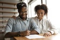 Happy biracial couple sign deal in office Royalty Free Stock Photo