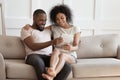 Happy biracial couple watch video on laptop at home together Royalty Free Stock Photo