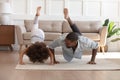 Happy biracial dad and daughter do morning gymnastics at home Royalty Free Stock Photo